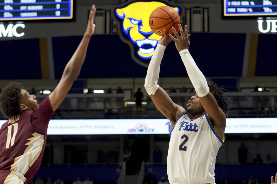 Pittsburgh's Blake Hinson (2) shoots against Florida State's Baba Miller (11) during the second half of an NCAA college basketball game Tuesday, March 5, 2024, in Pittsburgh. (AP Photo/Matt Freed)