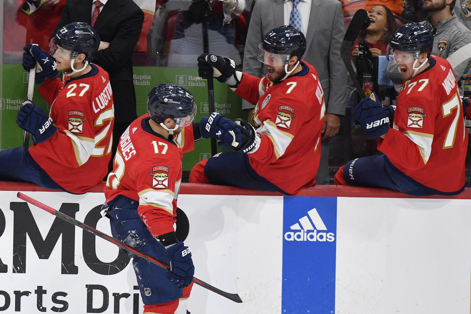 Florida Panthers center Evan Rodrigues (17) is congratulated by teammates after scoring during the third period of Game 2 of the NHL hockey Stanley Cup Finals against the Edmonton Oilers, Monday, June 10, 2024, in Sunrise, Fla. (AP Photo/Michael Laughlin)