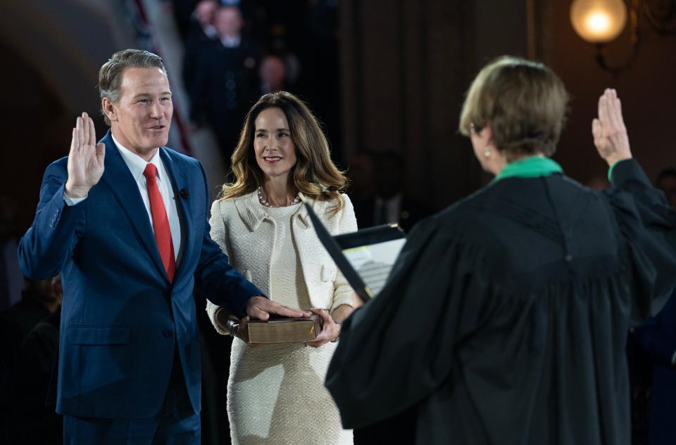 Lieutenant Governor Jon Husted is accompanied by his wife Tina Husted as he is sworn in during the inaugural ceremony at the Ohio Statehouse on Monday.