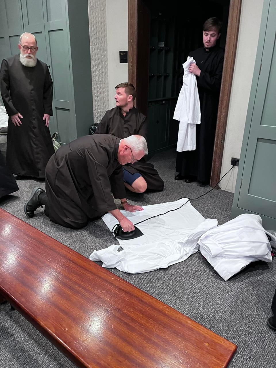 Jim Anderson does some last-minute ironing before performing at St Paul’s Cathedral, while Roger Johnson, from left, Adam Ballintoy, and Ashton Arndt wait their turns.