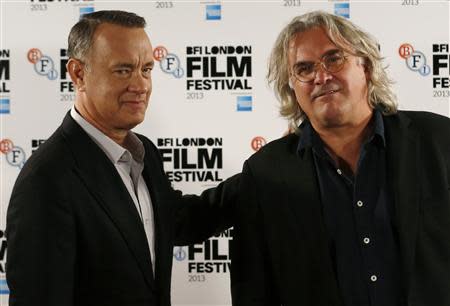 Actor Tom Hanks (L) and director Paul Greengrass attend a photocall for their film "Captain Phillips" during the BFI (British Film Institute) London Film Festival October 9, 2013. REUTERS/Luke MacGregor