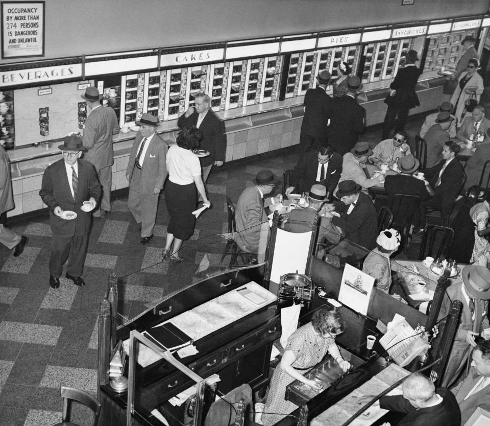 A man ordering a pie at a Horn & Hardart’s Automat