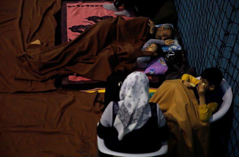 People rest at a temporary shelter camp in a basketball arena, after an earthquake in Elazig