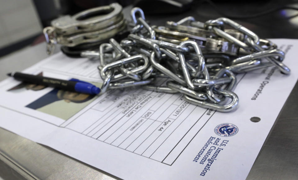 Handcuffs and chains sit on the paperwork of a person arrested by Immigration and Customs Enforcement officers in New York. 