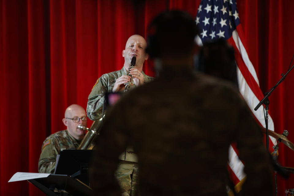 U.S. Army Field Band members, Chief Warrant Officer 2 Kevin Pick, on the tuba, left and Master Sgt. Bradford Danho, on the clarinet, are spaced to allow for social distancing as they play during the rehearsal of their daily "We Stand Ready" virtual concert series at Fort George G. Meade in Fort Meade, Md., Wednesday, March 25, 2020. The Army Field Band's mission is to bring the military's story to the American people. And they're not letting the coronavirus get in the way. (AP Photo/Carolyn Kaster)