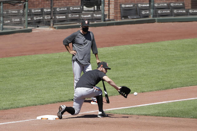 San Francisco Giants first baseman Brandon Belt, right, stands