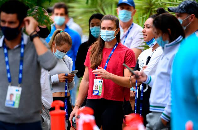 Tennis player Maria Sakkari of Greece (center) waits outside a hotel Thursday for a COVID-19 test in Melbourne.