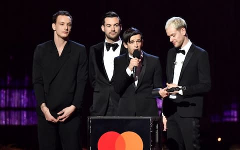  Ross MacDonald, Matthew Healy, George Daniel and Adam Hann of The 1975 win the award for Best British Group during The BRIT Awards  - Credit: Wireimage