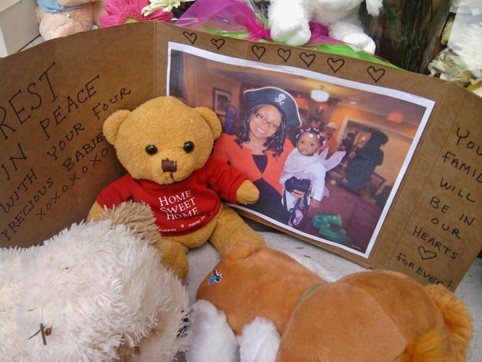 Stuffed animals, flowers, candles and cards from neighbors and friends form a memorial Tuesday, June 5, 2012, in front of the West Hartford, Conn. home of the Anyene family, who were all killed an airline crash in Nigeria. Sunday's crash five miles from Lagos' international airport killed all 153 people aboard including Maimuna Anyene, her husband, Onyeke, and their four children including 1-year-old twins, a 5-month-old and a 3-year-old. An untold number of people on the ground also died. (AP Photo/David Collins)