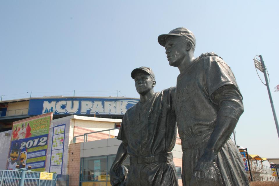 This undated image provided by the Brooklyn Cyclones shows a statue of Pee Wee Reese and Jackie Robinson at MCU Park in the Coney Island section of the Brooklyn borough of New York, where the minor league Cyclones team plays. A new film, “42,” tells the inspiring story of how Robinson integrated Major League Baseball when he played for the Brooklyn Dodgers. The pedestal of the statue states that Reese, captain of the Dodgers, “stood by Jackie Robinson against prejudiced fans and fellow players” by walking over to Robinson, standing next to him and “silencing the taunts of the crowd” during a game in Cincinnati. (AP Photo/Brooklyn Cyclones)