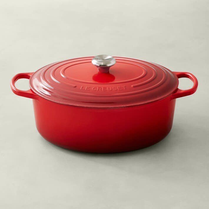 large red dutch oven on beige counter