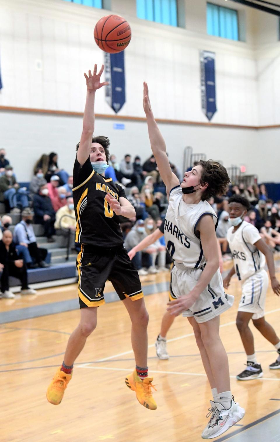 Jeffrey McCarthy of Nauset shoots over Jackson Rocco of Monomoy in this February 2022 game.