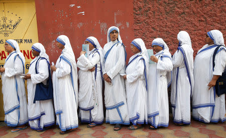 Catholic nuns from the Missionaries of Charity stand in a queue as they wait to cast their vote outside a polling station during the final phase of general election in Kolkata, India, May 19, 2019. REUTERS/Rupak De Chowdhuri