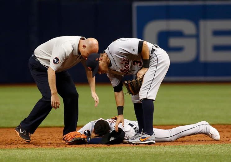Tigers shortstop Jose Iglesias is tended to after an awkward collision and game-ending throwing error. (Getty Images) 
