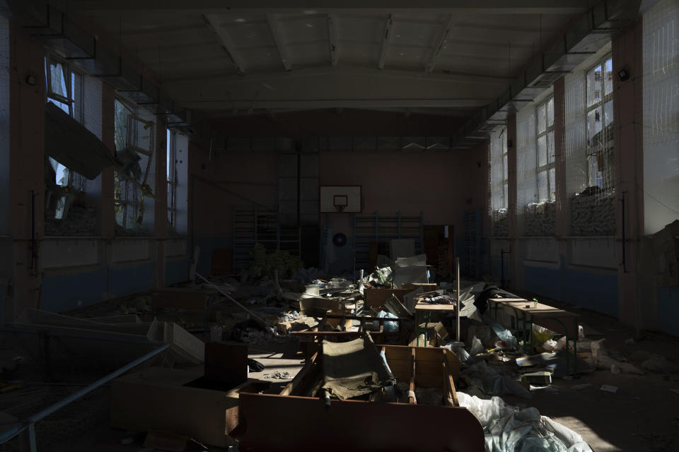 Debris is scattered inside a school which had been used by Russian forces as a headquarters and where civilians said they were held and tortured, in Izium, Ukraine, Wednesday, Sept. 21, 2022. (AP Photo/Evgeniy Maloletka)