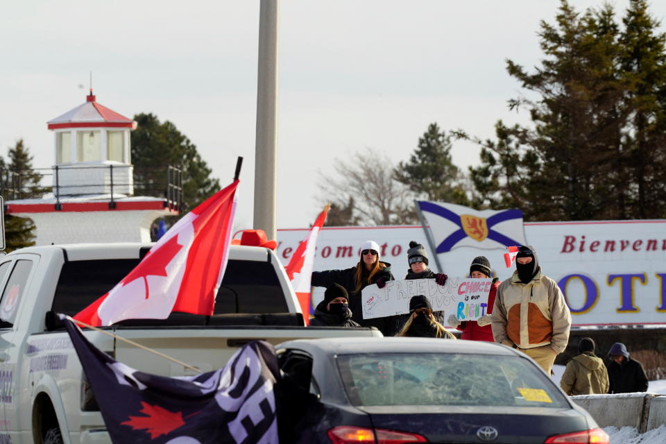 <p>A group of protesters stand alongside the Trans Canada Highway in support of the Canadian truck convoy/protest in Fort Lawrence, Nova Scotia, Canada, January 23, 2022. REUTERS/John Morris</p> 