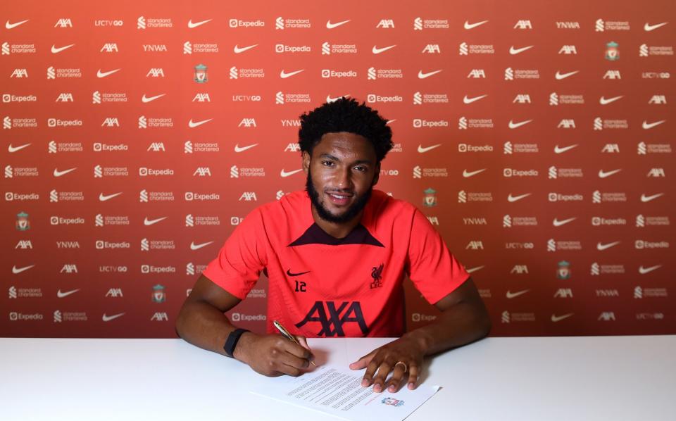 Joe Gomez signing his new Liverpool contract in 2022