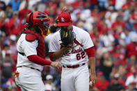 St. Louis Cardinals catcher Yadier Molina talks with starting pitcher Jose Quintana during the third inning in Game 1 of a National League wild card baseball playoff series against the Philadelphia Phillies, Friday, Oct. 7, 2022, in St. Louis. (AP Photo/Jeff Roberson)