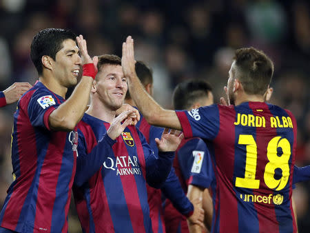 Barcelona's Lionel Messi (C), Luis Suarez (L) and Jordi Alba celebrate a goal against Cordoba during their Spanish First division soccer match at Camp Nou stadium in Barcelona December 20, 2014. REUTERS/Albert Gea