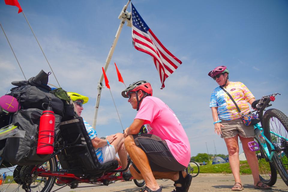 YouTube star Ryan Van Duzer, center, talks with Sandy Plante, 83, of Orlando, Florida, left, and her daughter Mel Steele of Colorado Springs, Colorado, at the RAGBRAI tire dips site on the Missouri River in Sioux City on Saturday. Plante is riding her first RAGBRAI and was inspired by watching Van Duzer's videos on YouTube.