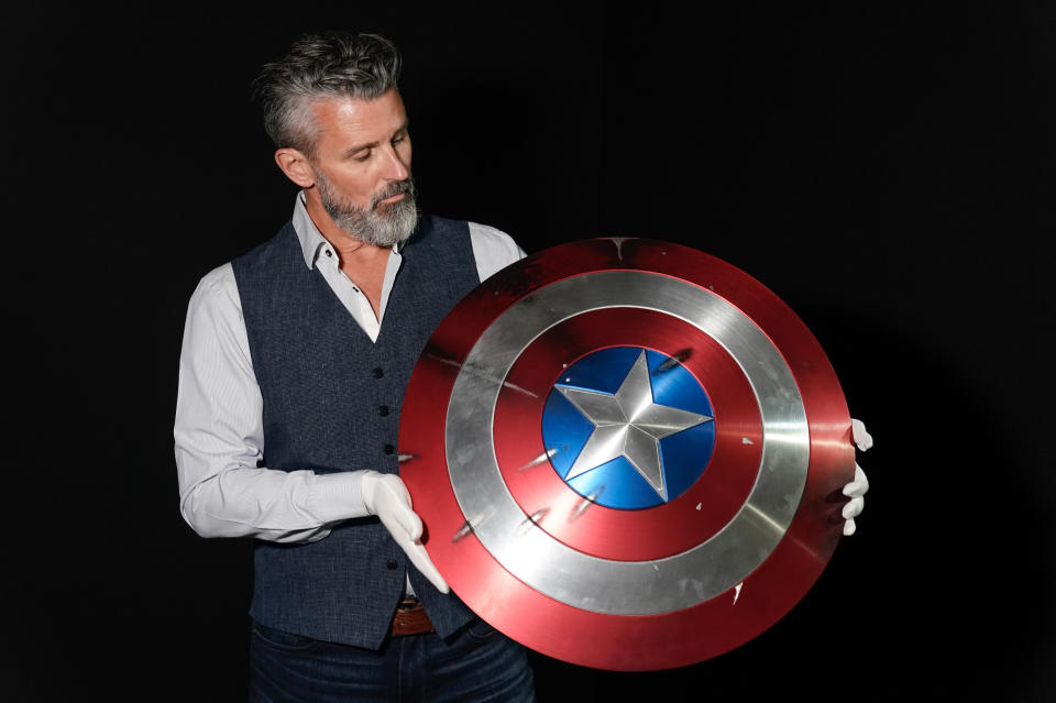 Propstore CEO Stephen Lane holds Chris Evans' Captain America shield from the 2011 film 'Captain America: The First Avenger' (estimate £50,000 - 100,000) during a preview for the showbiz memorabilia auction, at the Propstore in Rickmansworth, Hertfordshire. Picture date: Wednesday September 20, 2023. (Photo by Andrew Matthews/PA Images via Getty Images)