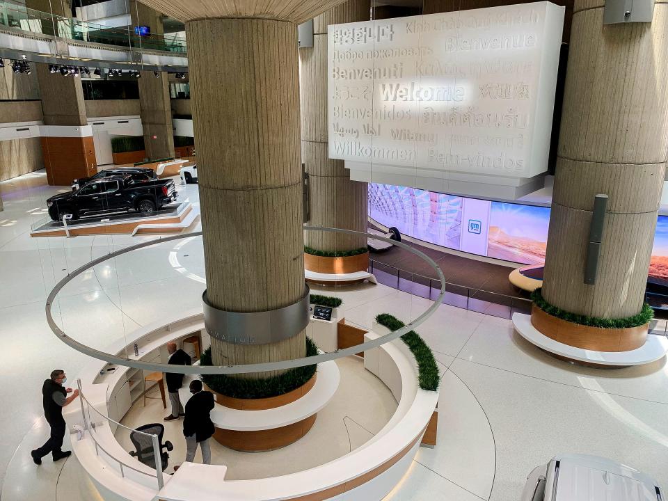 People talk at the welcome desk in the atrium area at the Renaissance Center on June 15, 2022.