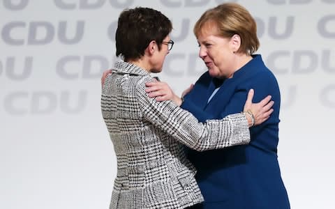 Angela Merkel congratulates Annegret Kramp-Karrenbauer, after she won the party's election to become the new CDU leader - Credit:  Krisztian Bocsi/Bloomberg