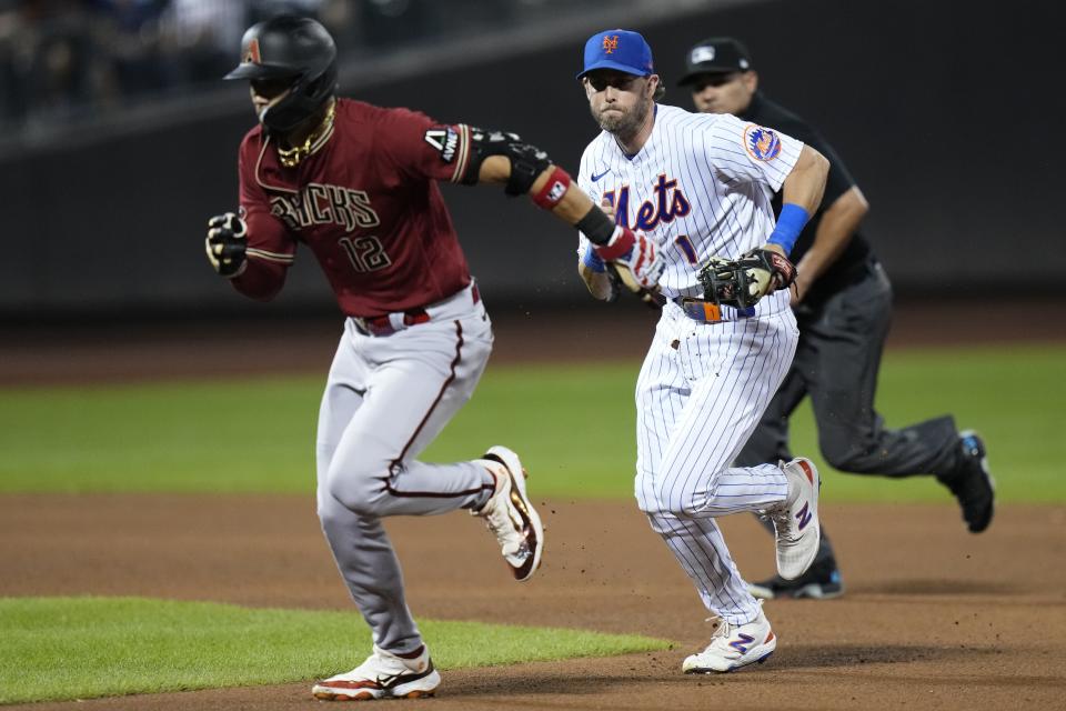 New York Mets second baseman Jeff McNeil (1) runs down Arizona Diamondbacks' Lourdes Gurriel Jr. (12) for an out during the fourth inning of a baseball game Wednesday, Sept. 13, 2023, in New York. (AP Photo/Frank Franklin II)