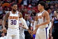 Feb 25, 2019; Miami, FL, USA; Phoenix Suns guard Troy Daniels (left) greets guard Devin Booker (right) during the second half against the Miami Heat at American Airlines Arena. Mandatory Credit: Steve Mitchell-USA TODAY Sports