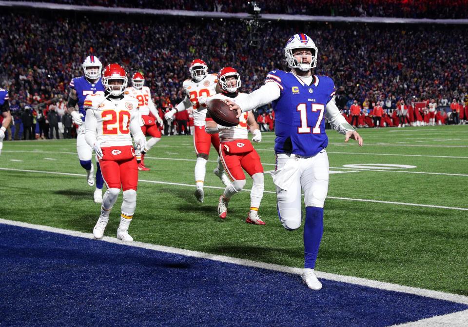 Buffalo Bills quarterback Josh Allen (17) scores a first half touchdown against the Chiefs .