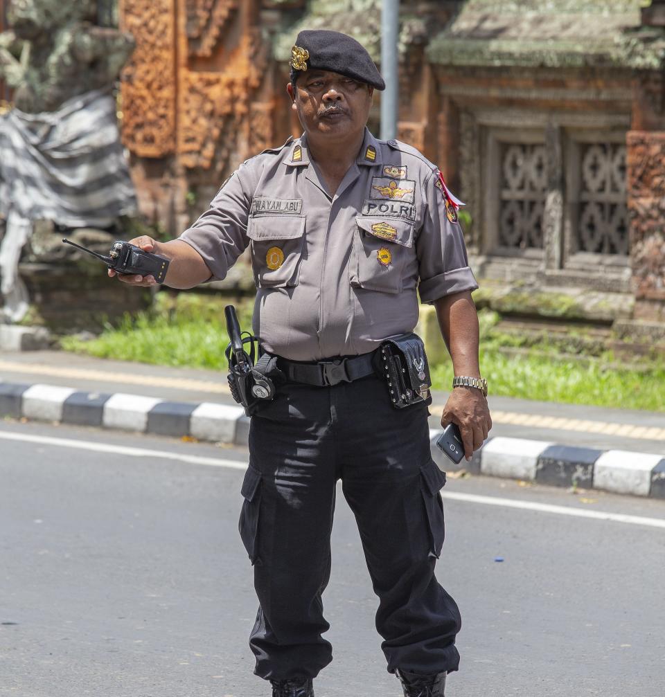 A Balinese police officer standing in the street