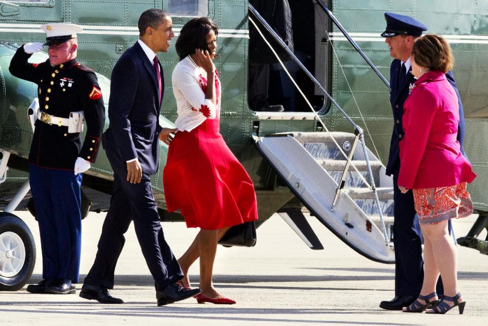 President Barack Obama and first lady Michelle Obama are greeted by Col. Dale S. Holland, Vice Commander of the 89th Airlift Wing, and his wife Michelle Holland, before boarding Air Force One at Andrews Air Force Base, Md., Friday, April 27, 2012, prior to traveling to Fort Stewart in Ga. (AP Photo/Jacquelyn Martin)