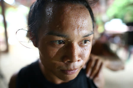 Muay Thai boxer Nong Rose Baan Charoensuk, who is transgender, receives a massage during a training session at a gym in Buriram province, Thailand, July 4, 2017. REUTERS/Athit Perawongmetha