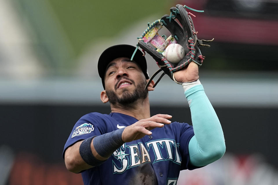 Seattle Mariners second baseman Jose Caballero makes a catch on a ball hit by Los Angeles Angels' Brandon Drury during the third inning of a baseball game Sunday, June 11, 2023, in Anaheim, Calif. (AP Photo/Mark J. Terrill)