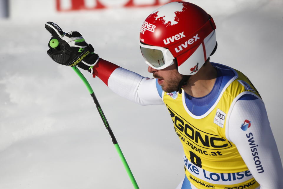 Switzerland's Carlo Janka reacts in the finish area following his run in the men's World Cup downhill ski race in Lake Louise, Alberta, Canada, on Saturday, Nov. 30, 2019. (Jeff McIntosh/The Canadian Press via AP)