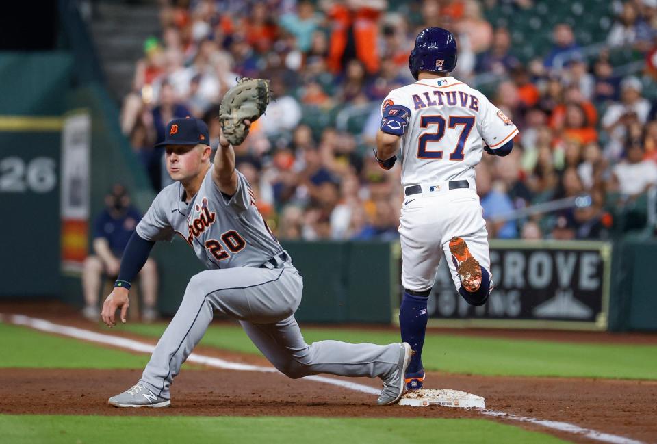 Houston Astros second baseman Jose Altuve (27) is safe on an infield single as Detroit Tigers first baseman Spencer Torkelson (20) fields a throw during the third inning at Minute Maid Park.