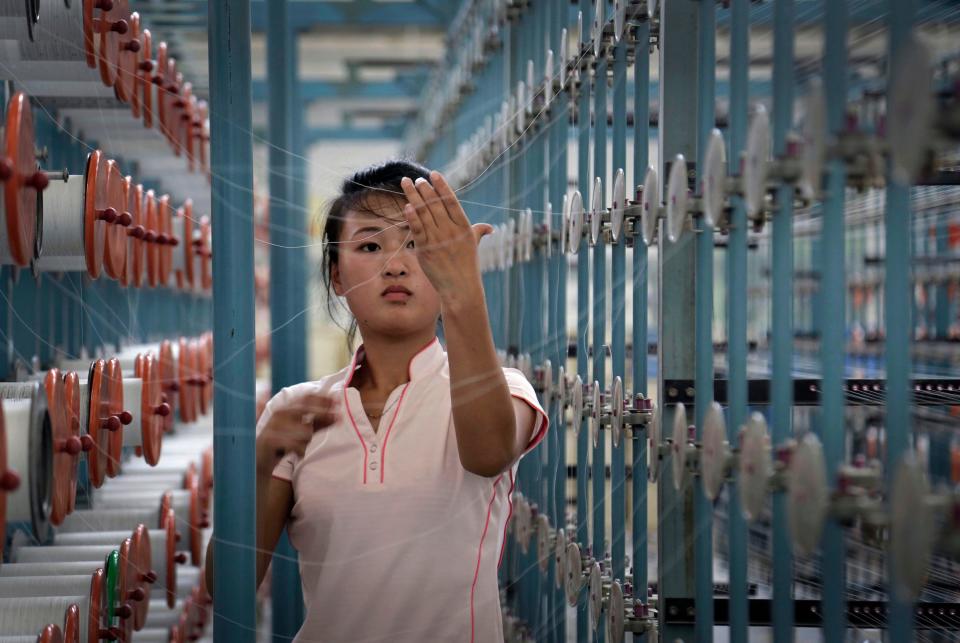 A woman works at the Kim Jong Suk Pyongyang textile factory in Pyongyang, North Korea, on July 31, 2014.