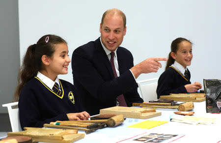 Britain's Prince William joins local school children from St Cuthbert with St Matthias CE Primary School at a copper beating workshop during the official opening of Japan House in London, Britain, September 13, 2018. Tim P. Whitby/Pool via REUTERS