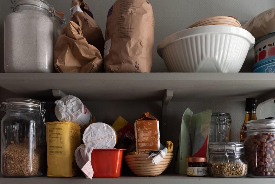 kitchen shelves with various food items in bags and jars