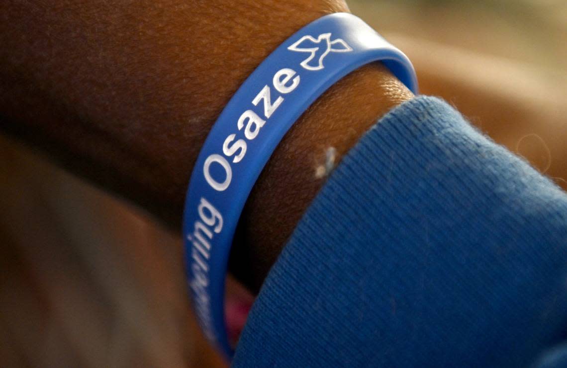Yum Yum Abdul, who was a friend of Osaze Osagie, wears a wristband in remembrance of him during the Osaze’s Heart Scholarship fundraiser dinner on Tuesday, March 19, 2024 at the State College Access Church.