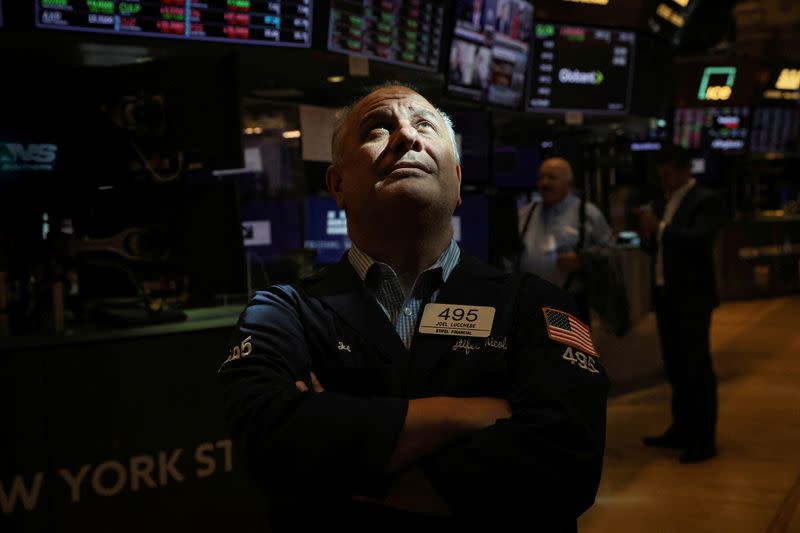 FILE PHOTO: Traders work on the floor of the NYSE in New York