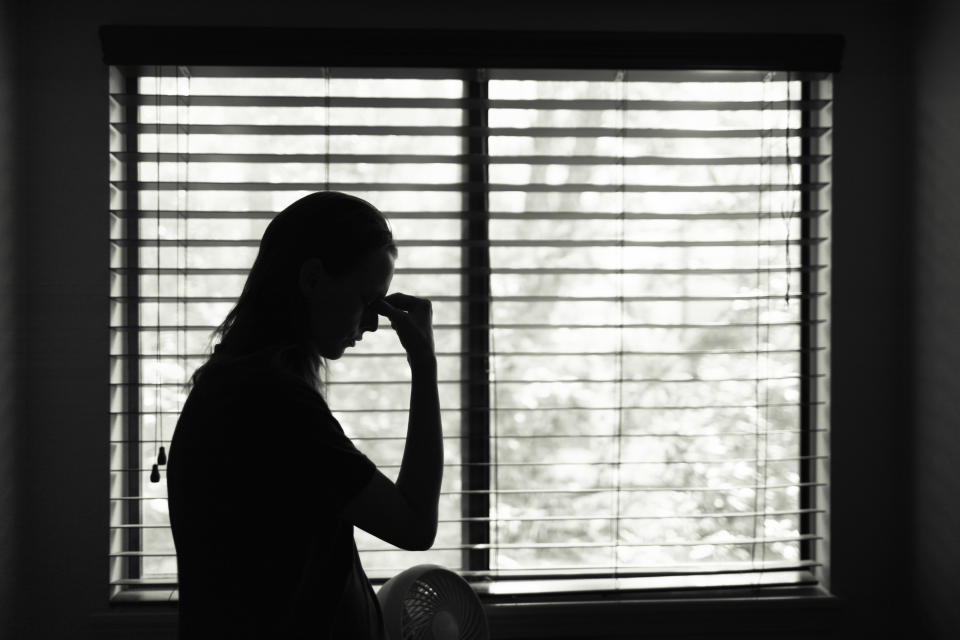 Stressed young woman in the bedroom.