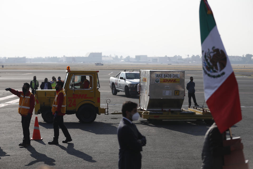 The first shipment of the Pfizer COVID-19 vaccine to Mexico is transported on the tarmac after being unloaded from a DHL cargo plane at the Benito Juarez International Airport in Mexico City, Wednesday, Dec. 23, 2020. (AP Photo/Eduardo Verdugo)