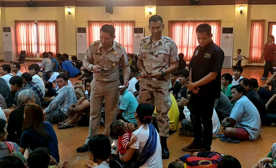 In this Aug. 28, 2018, photo, Thai officers talks to refugee and asylum seekers in Bangkok, Thailand. Thai police rounded up more than 160 refugees and asylum seekers from ethnic minorities in Vietnam and Cambodia who are believed to be at risk of persecution if they are returned to their homelands. (AP Photo)