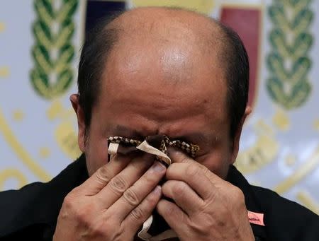 Arturo Lascanas, a retired Davao policeman, wipes his tears during a news conference at the Senate headquarters in metro Manila, Philippines February 20, 2017. REUTERS/Romeo Ranoco