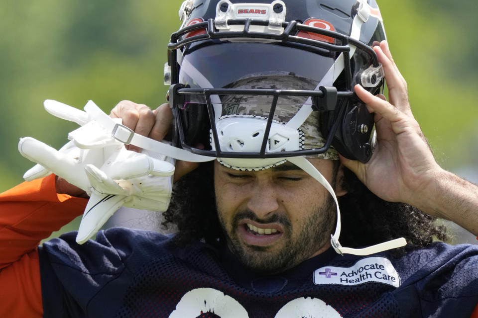 Chicago Bears wide receiver Dante Pettis puts on his helmet during NFL football OTA practice in Lake Forest, Ill., Wednesday, June 7, 2023. (AP Photo/Nam Y. Huh) ORG XMIT: ILNH118