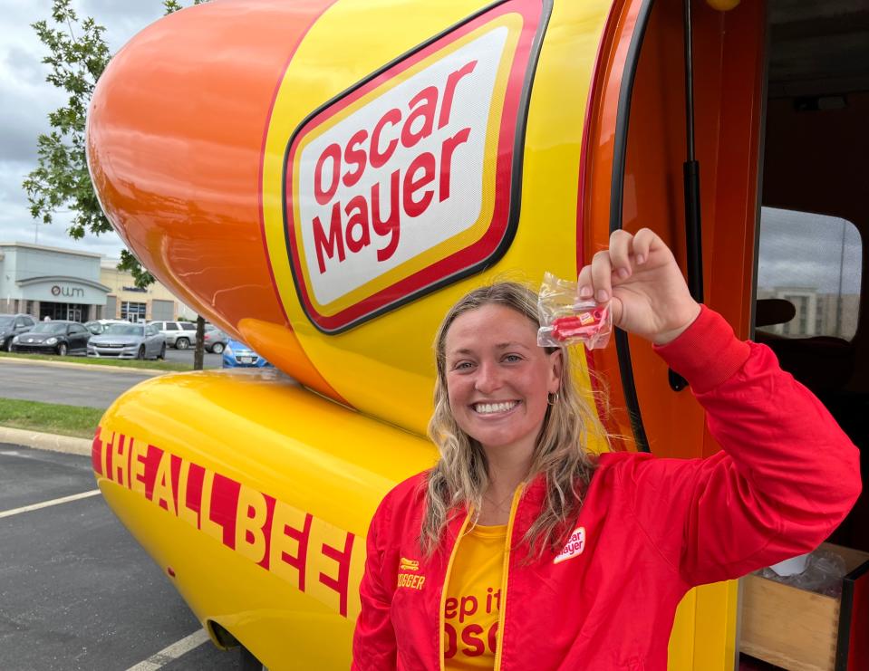 Anna Murphy-Pociask, on the marketing team at Oscar Mayer, is shown with the iconic Frankmobile while holding a wienie whistle. The unique vehicle will be in downtown Canton on Friday.