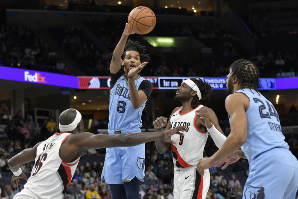 Memphis Grizzlies forward Ziaire Williams (8) passes to forward Lamar Stevens (24), between Portland Trail Blazers center Duop Reath (26) and forward Jerami Grant (9) during the first half of an NBA basketball game Saturday, March 2, 2024, in Memphis, Tenn. (AP Photo/Brandon Dill)