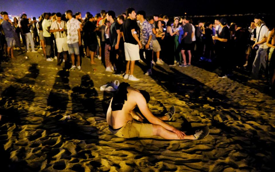 Tourists and locals gather at the Barceloneta beach, as indoor nightlife venues were shut again by Catalonia's regional government in a bid to stop the increase of Covid-19 cases in Barcelona, Spain - Nacho Doce/Reuters