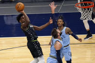 Minnesota Timberwolves' Anthony Edwards, left, shoots over Memphis Grizzlies' Jonas Valanciunas, center, during the first half of an NBA basketball game Wednesday, May 5, 2021, in Minneapolis. (AP Photo/Jim Mone)